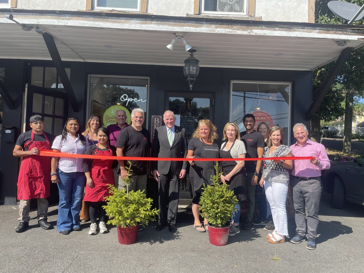 A group of people gathered for the ribbon-cutting at Cucina Daniella