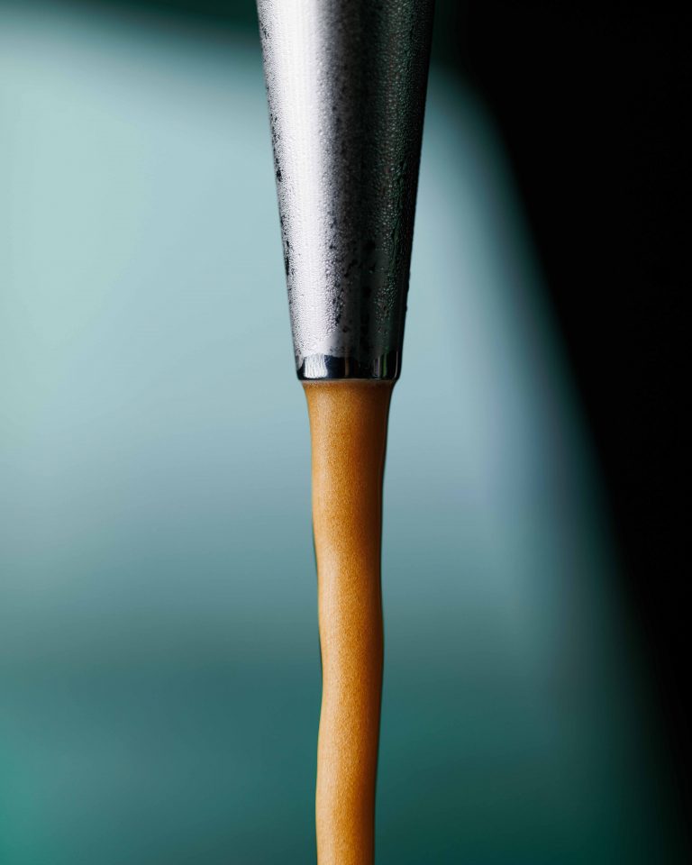 Michael Palladini standing next to a TapThat Vending machine