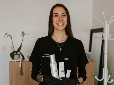 Paulina Lacapra of Green Moon Spa holding beauty products in her store