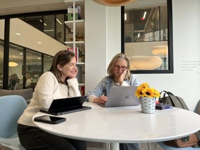 CTSBDC Advisor Christine Sullivan and HAYVN owner Felicia Rubinstein working at a table together in the coworking space