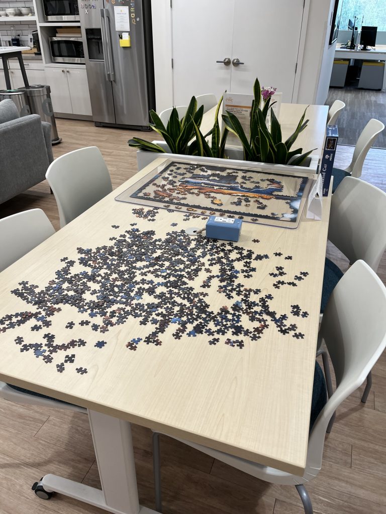 A puzzle comes together on the communcal puzzle table at HAYVN coworking space in Darien, CT