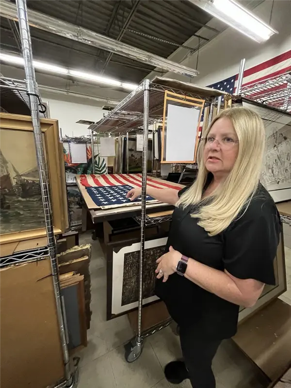 An art restorer repairing a painting