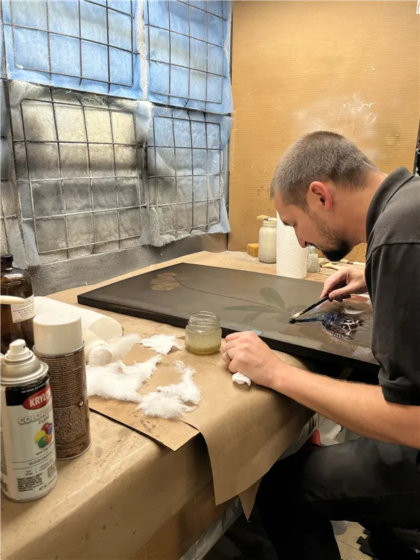 An art restorer repairing a painting