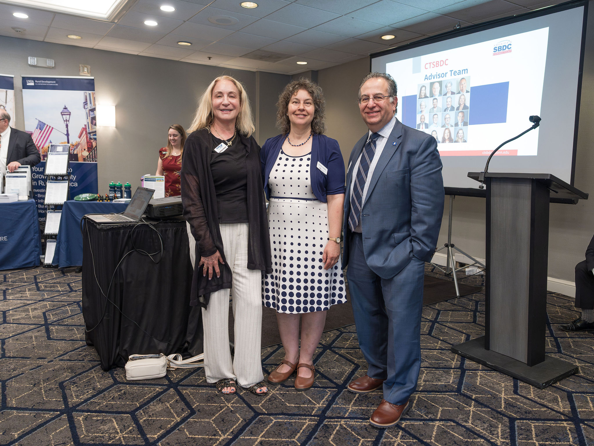 Three people smiling at the camera during the the SBA Lending Expo