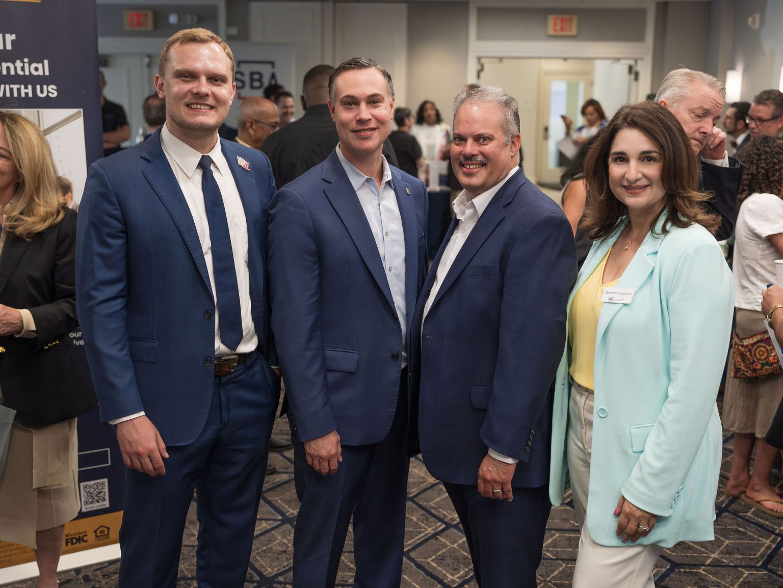 Three people smiling at the camera during the the SBA Lending Expo