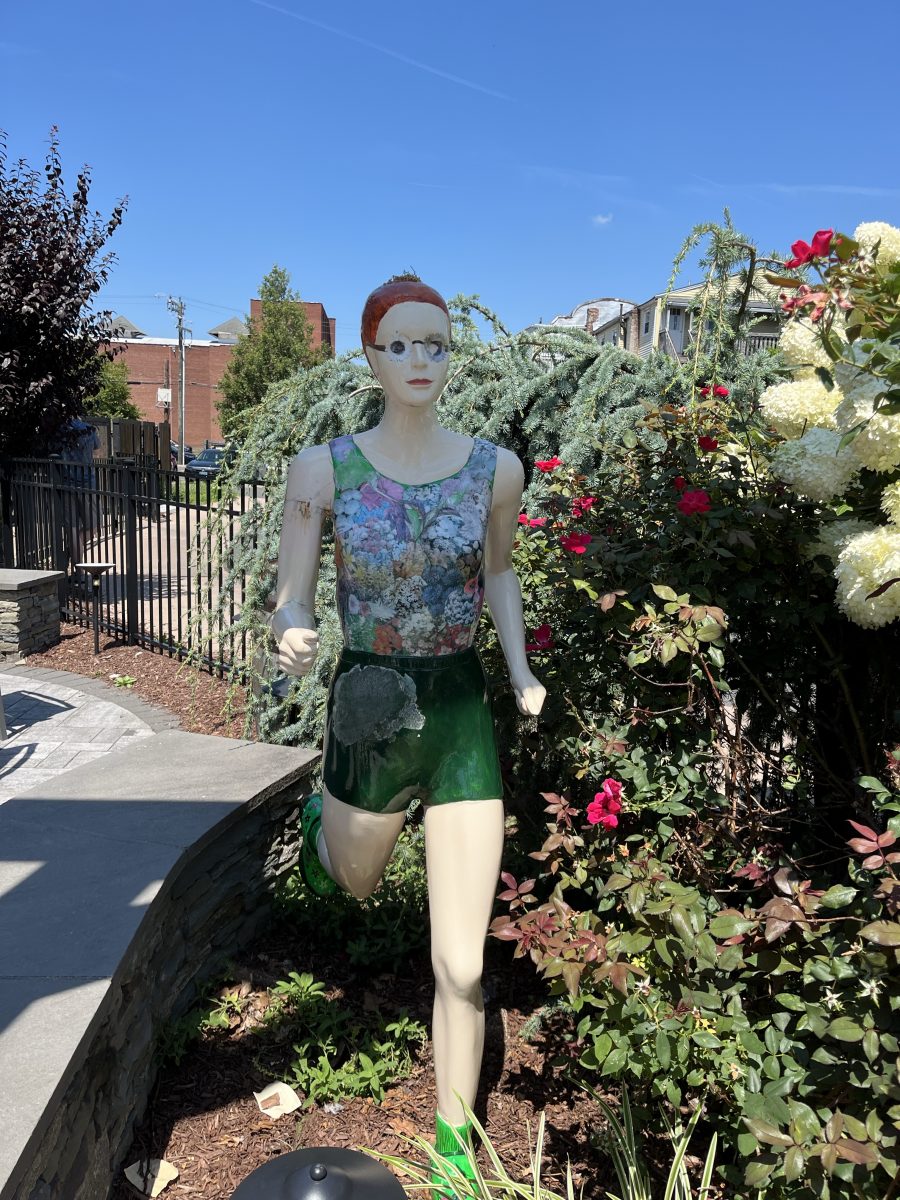 A statue of a runner promoting the Manchester Road Race at Urban Lodge.